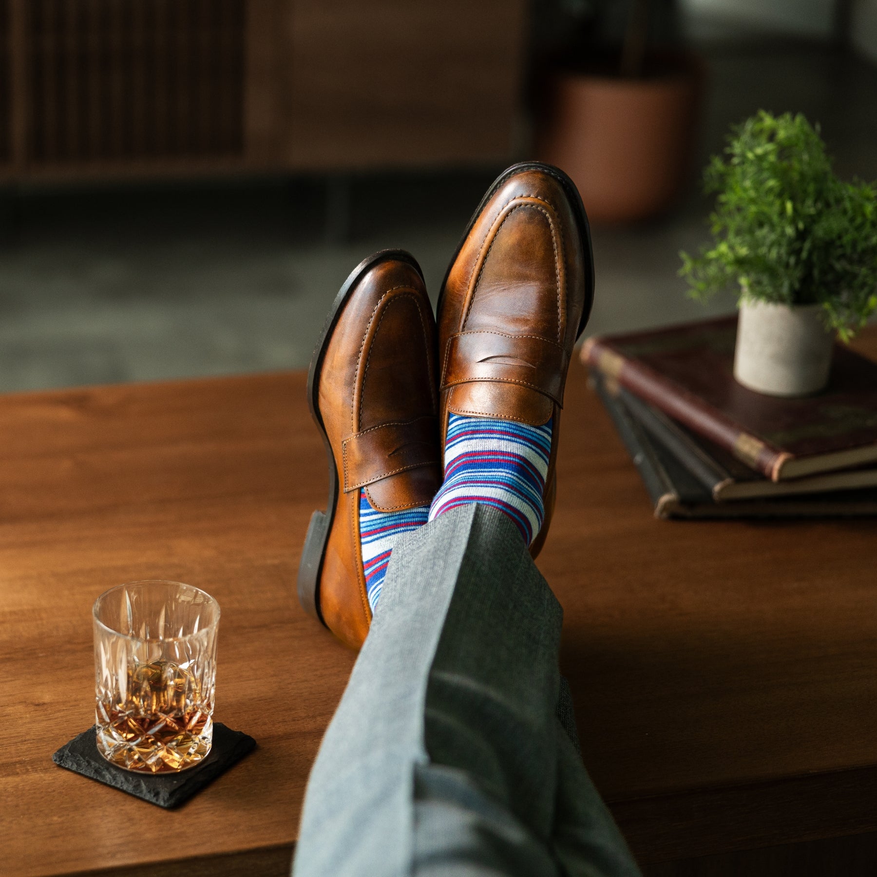 A blue, red, and grey striped men's dress sock