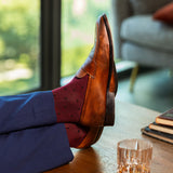 A deep red men's dress sock with a navy micro-tile pattern