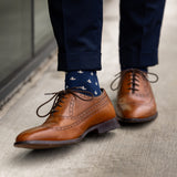A navy men's dress sock with a cream French motif pattern.
