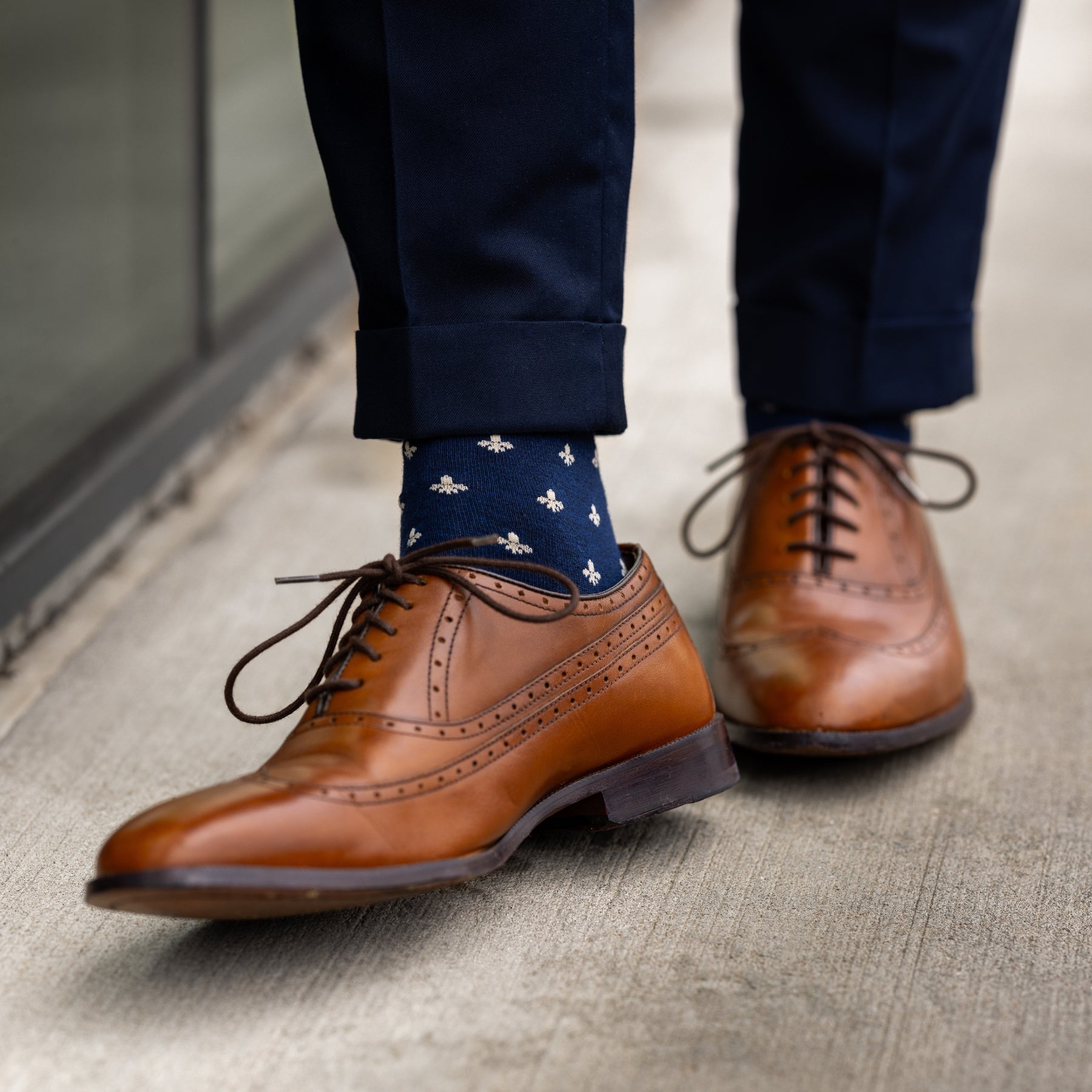 A navy men's dress sock with a cream French motif pattern.
