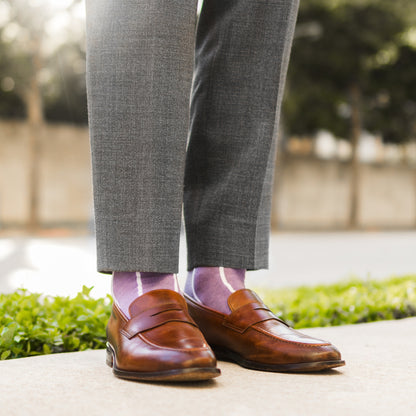 A lavender men's dress sock with a white vertical stripe pattern