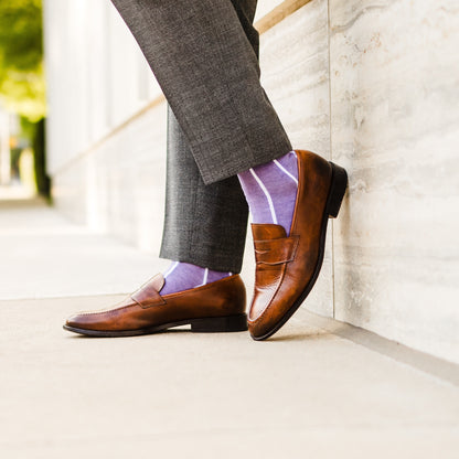 A lavender men's dress sock with a white vertical stripe pattern