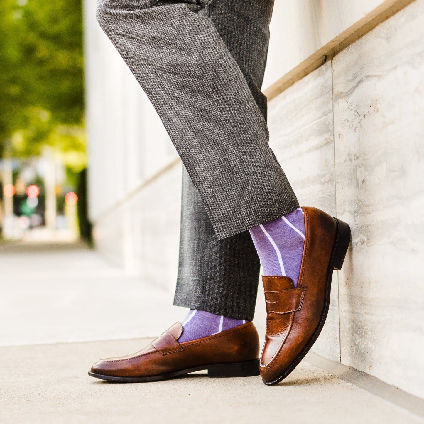 A lavender men's dress sock with a white vertical stripe pattern