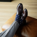 A navy men's dress sock with a cream French motif pattern.