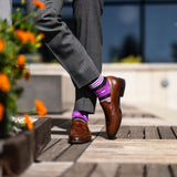 Vibrant purple men's dress sock with unique white and black stripe pattern