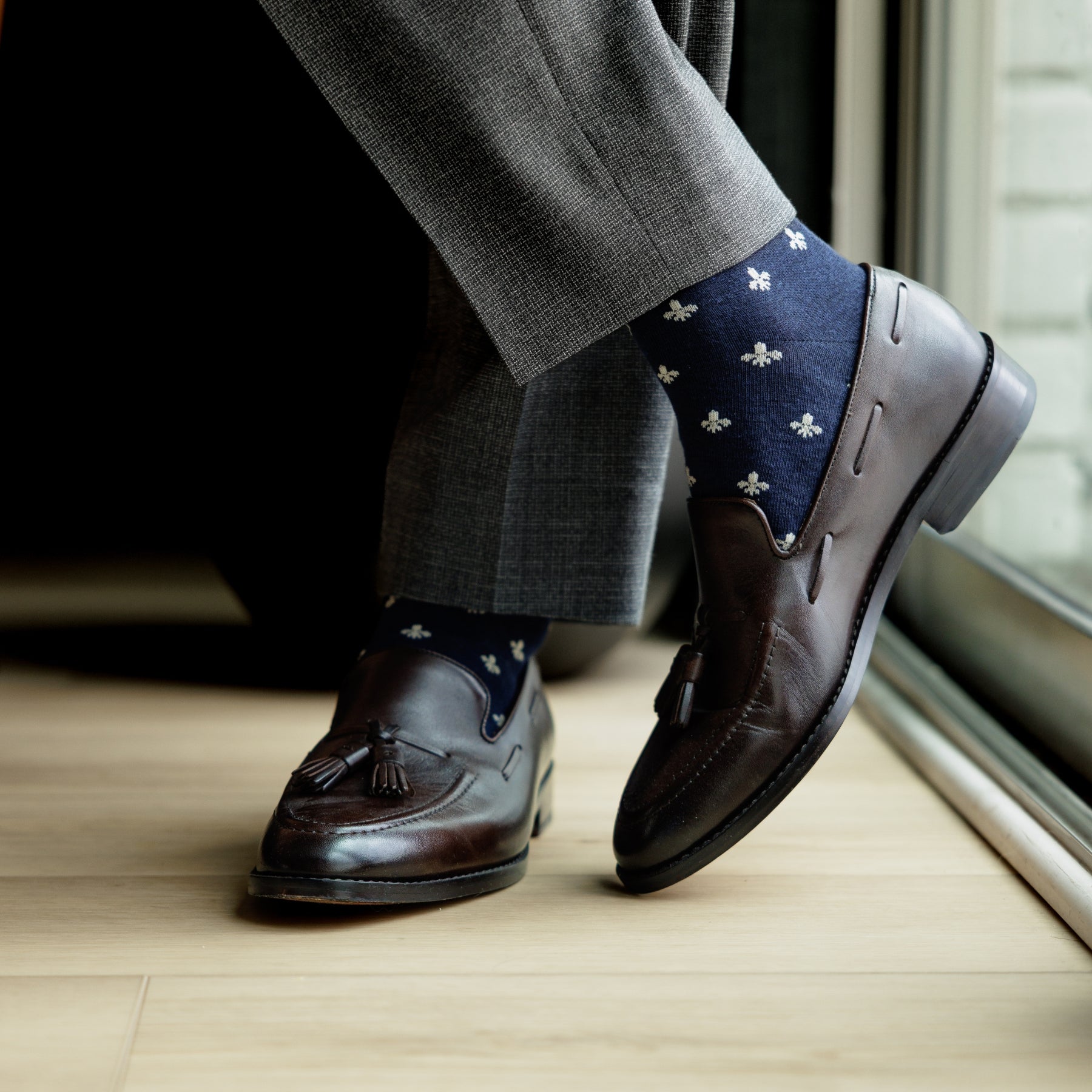 A navy men's dress sock with a cream French motif pattern.