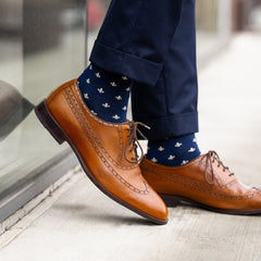 A navy men's dress sock with a cream French motif pattern.