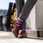 Vibrant purple men's dress sock with unique white and black stripe pattern