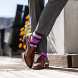 Vibrant purple men's dress sock with unique white and black stripe pattern