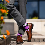 Vibrant purple men's dress sock with unique white and black stripe pattern