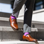 Vibrant purple men's dress sock with unique white and black stripe pattern