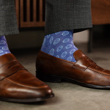 A heathered blue sock with light blue double dots