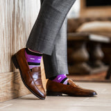 Vibrant purple men's dress sock with unique white and black stripe pattern