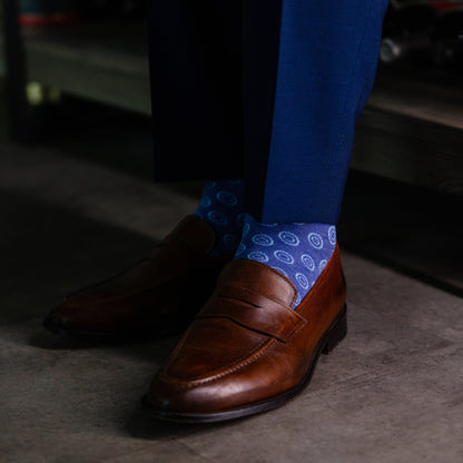 A heathered blue sock with light blue double dots