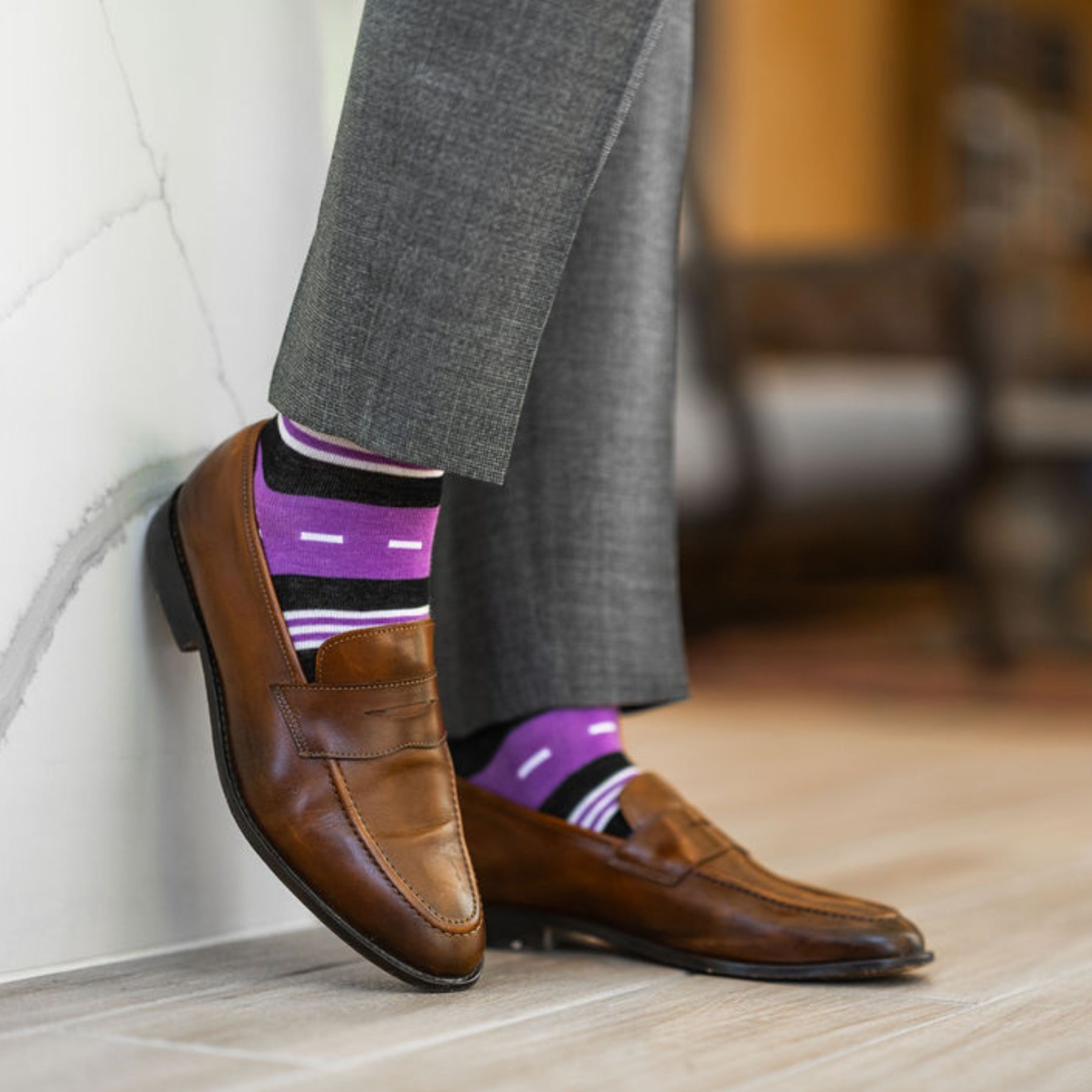 Vibrant purple men's dress sock with unique white and black stripe pattern