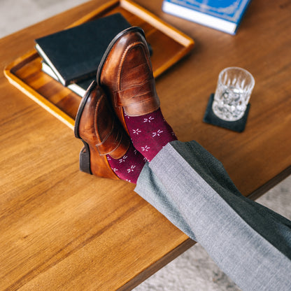 Deep red sock with a contrasting white firework pattern