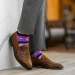 Vibrant purple men's dress sock with unique white and black stripe pattern