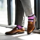 Vibrant purple men's dress sock with unique white and black stripe pattern