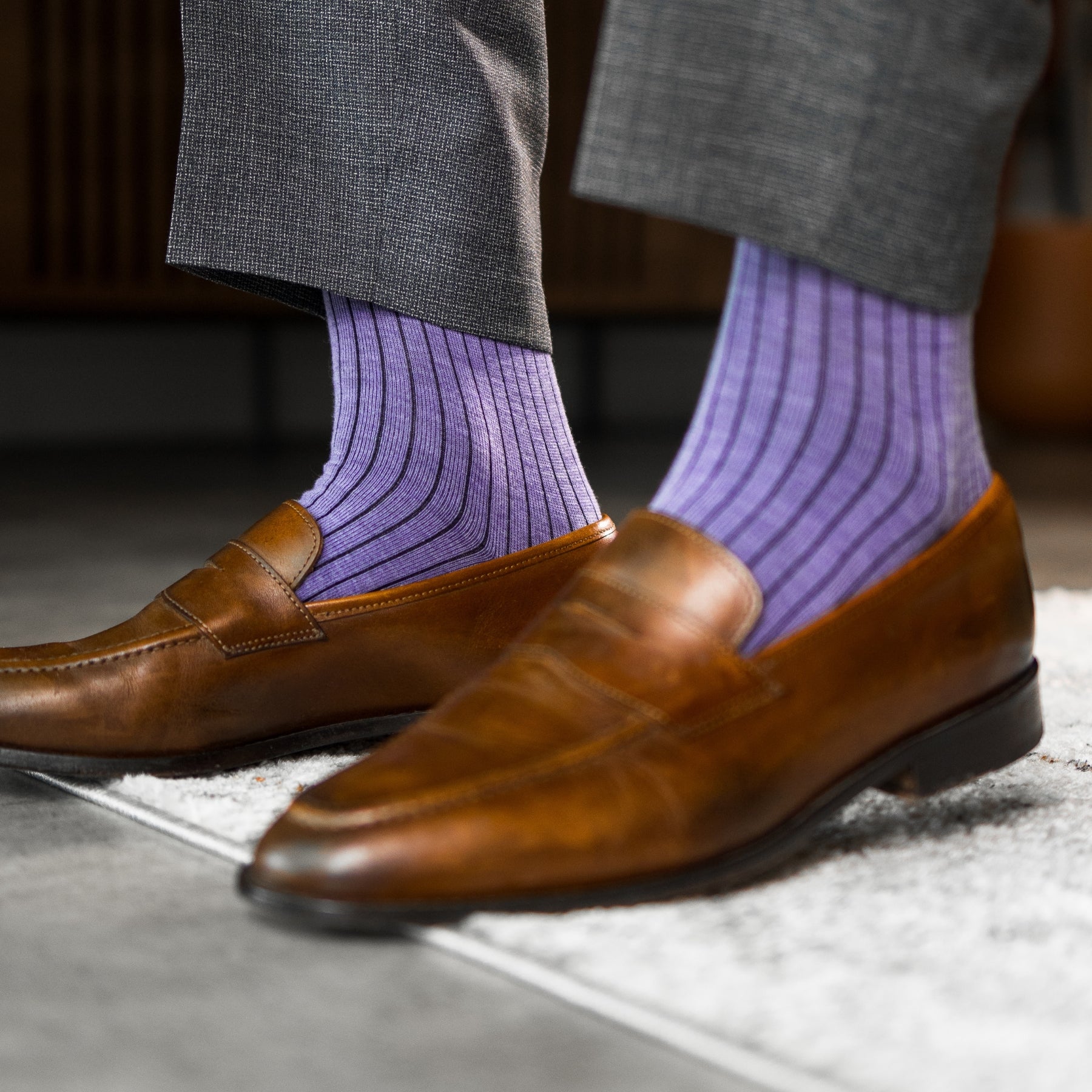 A lavender men's dress sock with a dark violet ribbed pattern