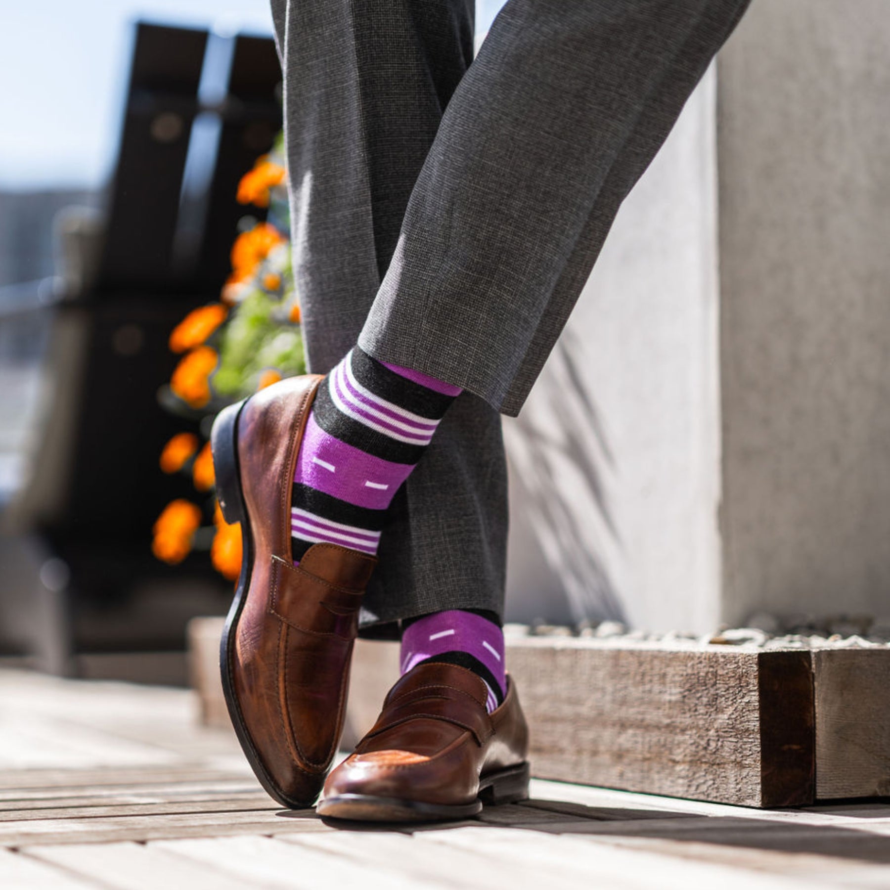 Vibrant purple men's dress sock with unique white and black stripe pattern