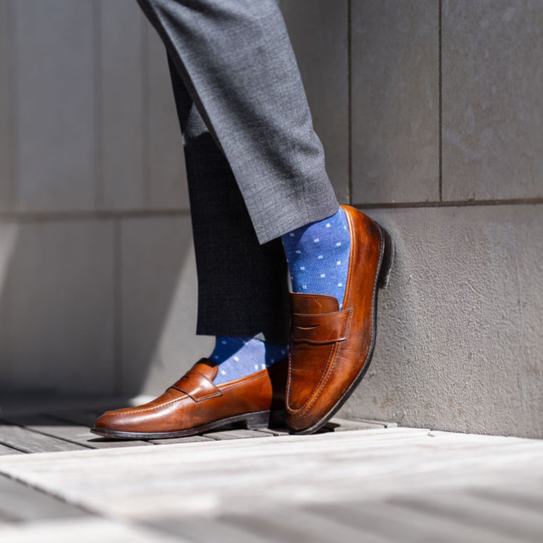 Man wearing heathered blue men's dress sock with ocean blue micro squares with grey slacks and brown shoes