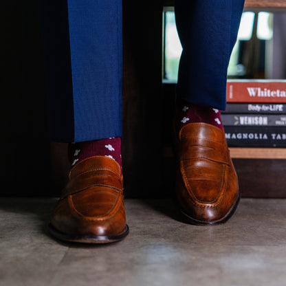 a deep red sock with a white hatch pattern