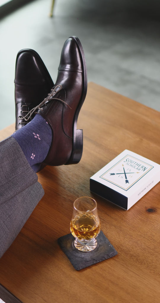 A Prussian Blue men's dress sock with a blush pink flower pattern