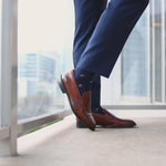 Navy men's dress socks with a gold flower pattern