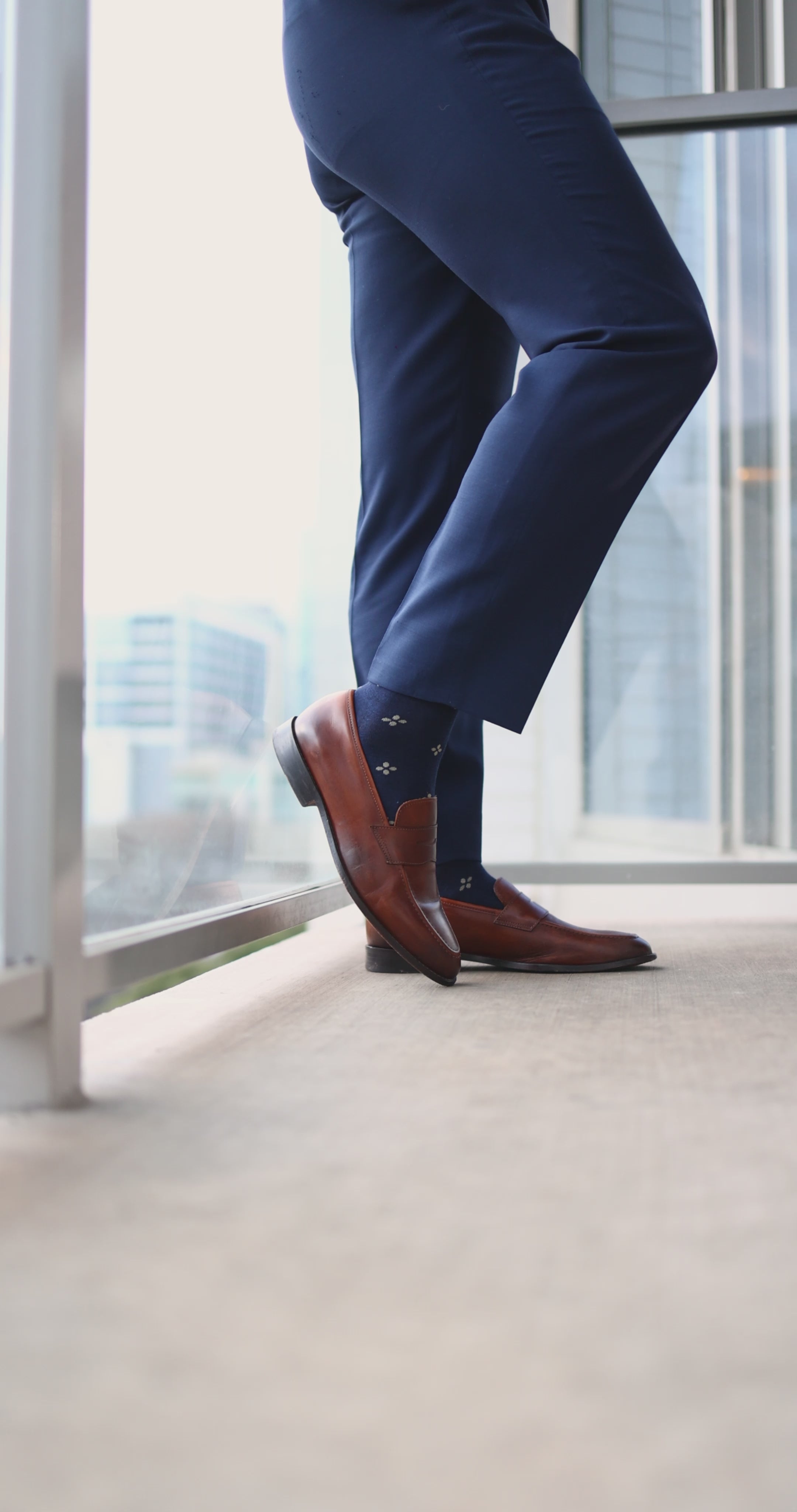 Navy men's dress socks with a gold flower pattern