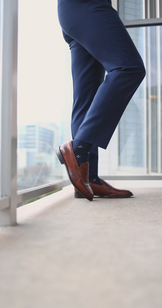 Navy men's dress socks with a gold flower pattern