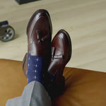 A navy men's dress sock with a white T-sun pattern