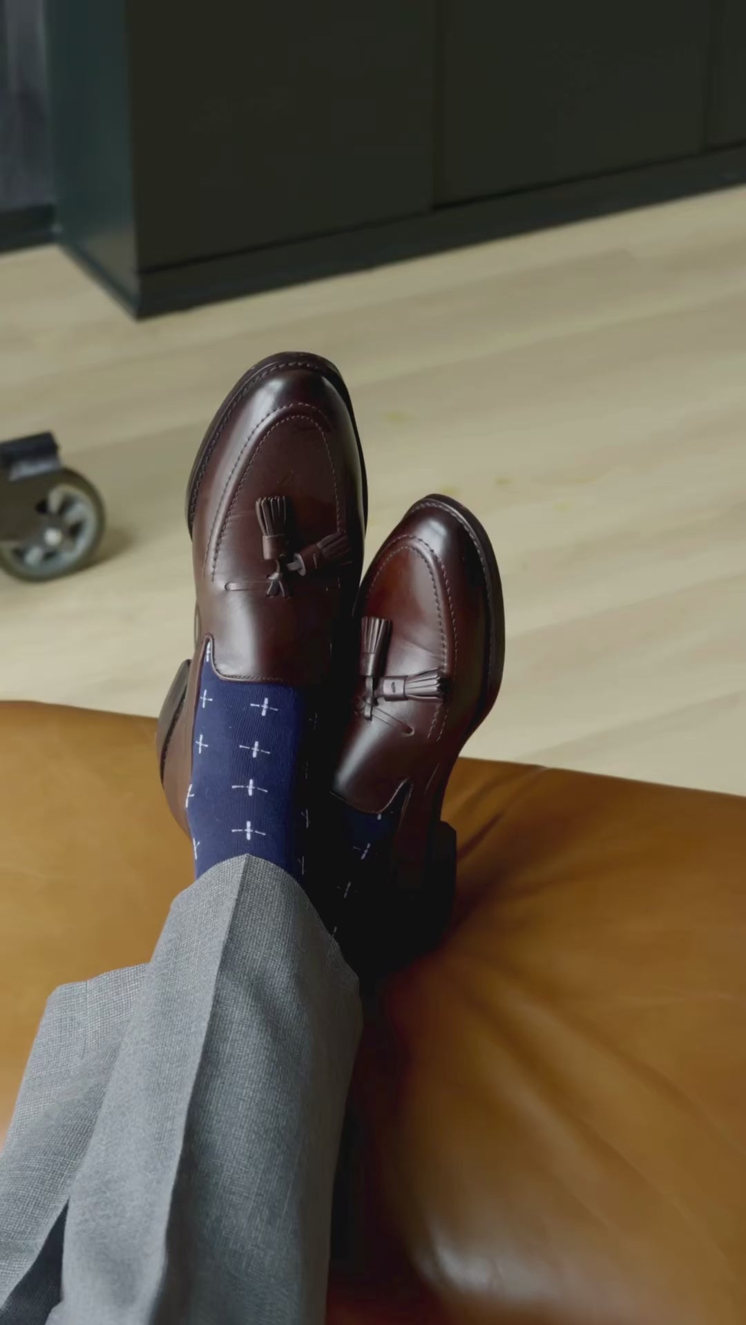 A navy men's dress sock with a white T-sun pattern