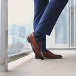 Navy men's dress socks with a gold flower pattern