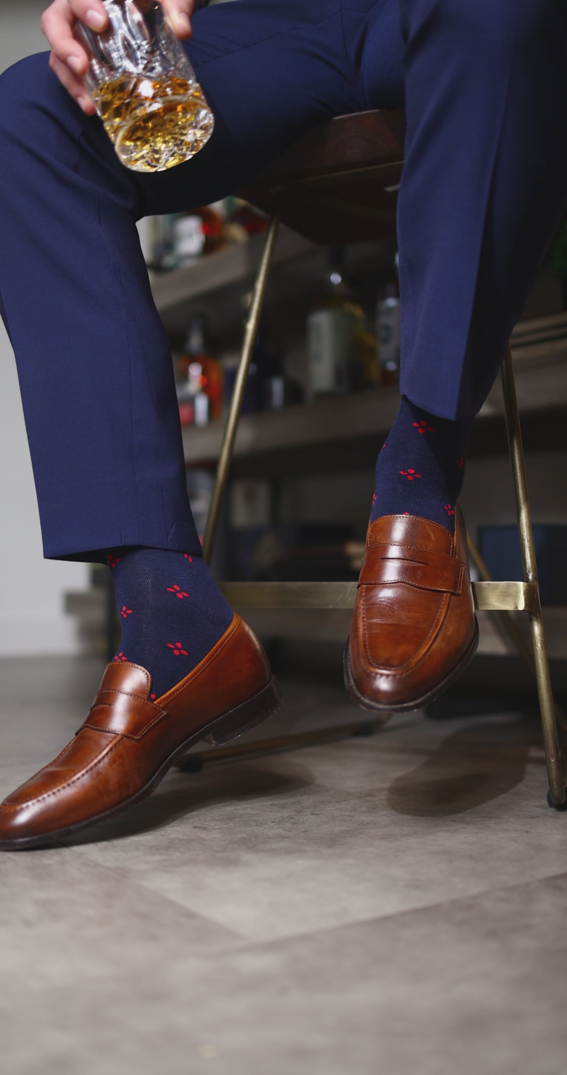 Navy blue men's sock with a cherry red flower pattern