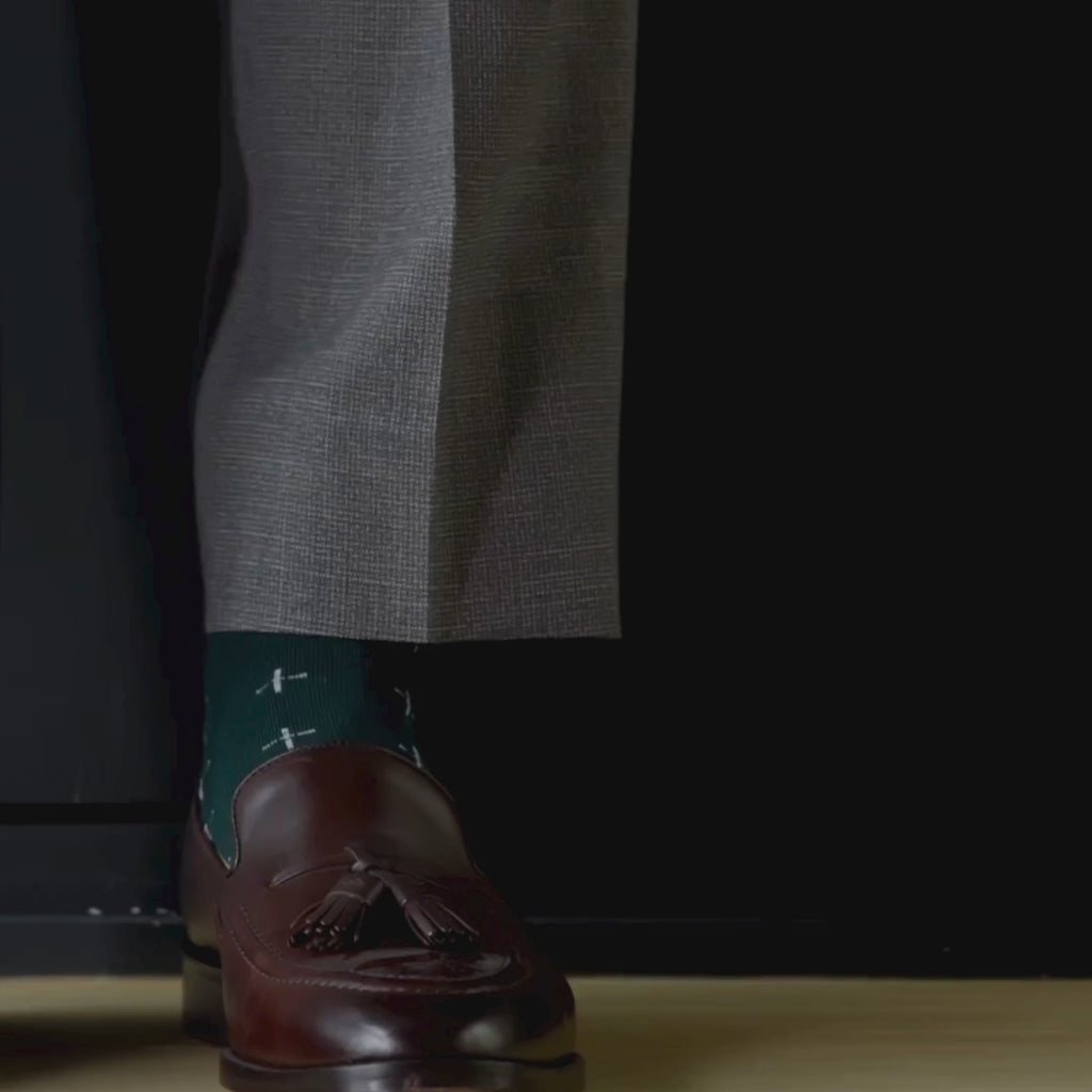 deep green men's dress sock with a white t-sun pattern