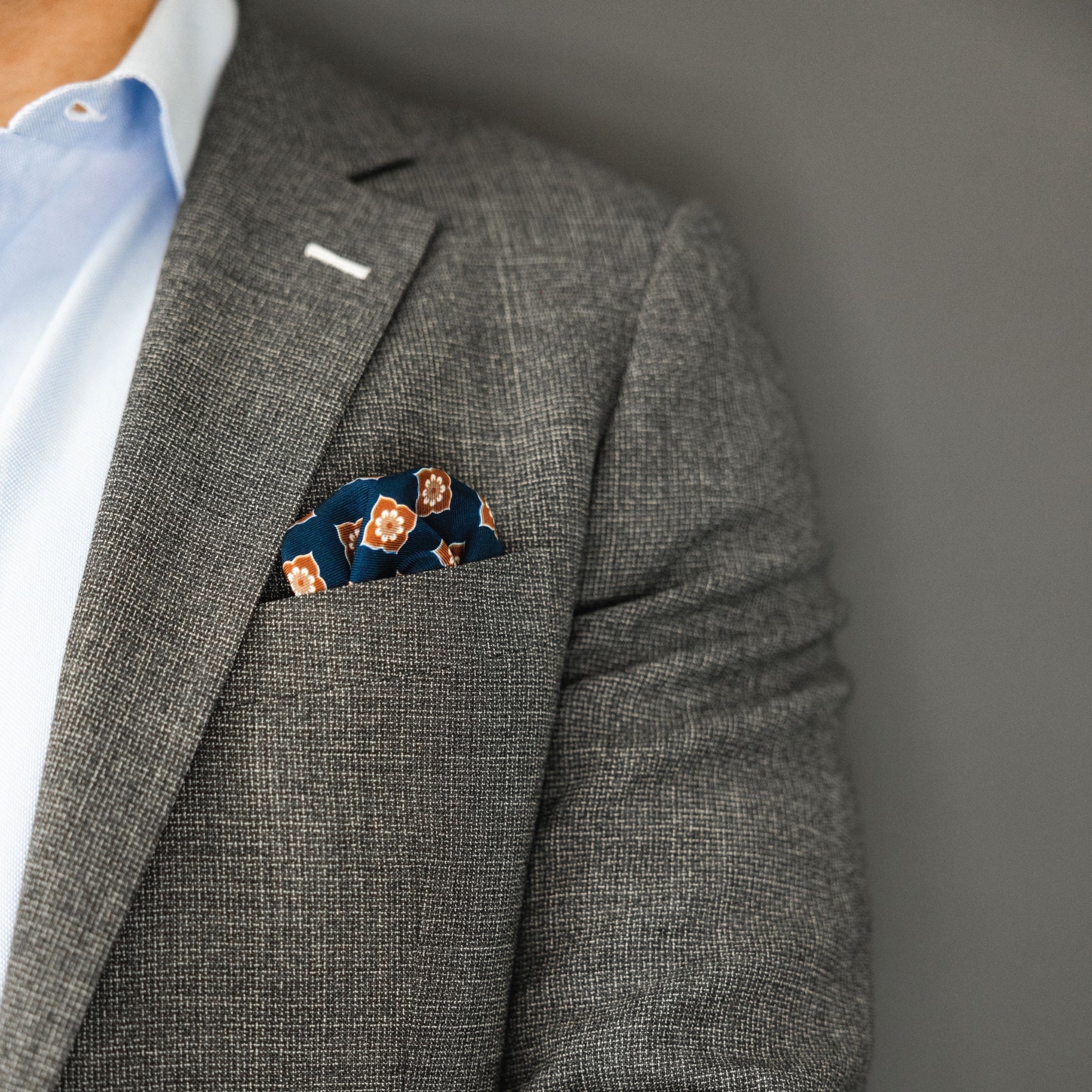 blue and brown floral patterned italian silk pocket square with grey suit and blue shirt