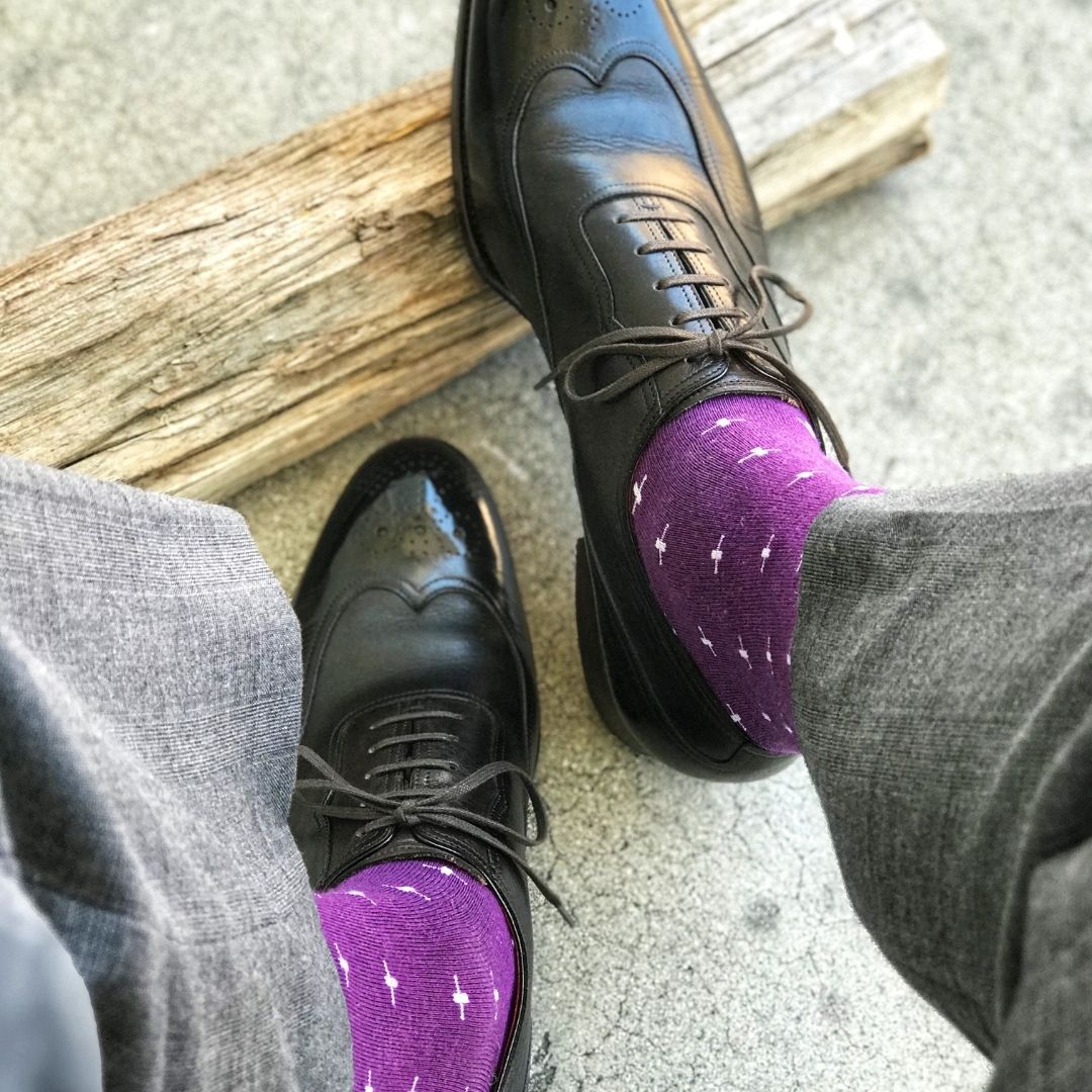 Man wearing purple dress socks with white hatches and dress shoes