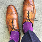 Man wearing purple dress socks with white hatches and brown dress shoes