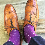 Man wearing purple dress socks with white hatches and brown dress shoes