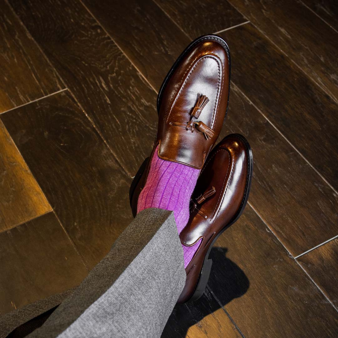 Man wearing fuchsia, solid, ribbed men's dress socks with brown shoes and gray 