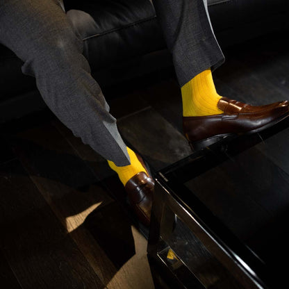 Man wearing honeycomb, solid, ribbed men's  dress socks with brown shoes.