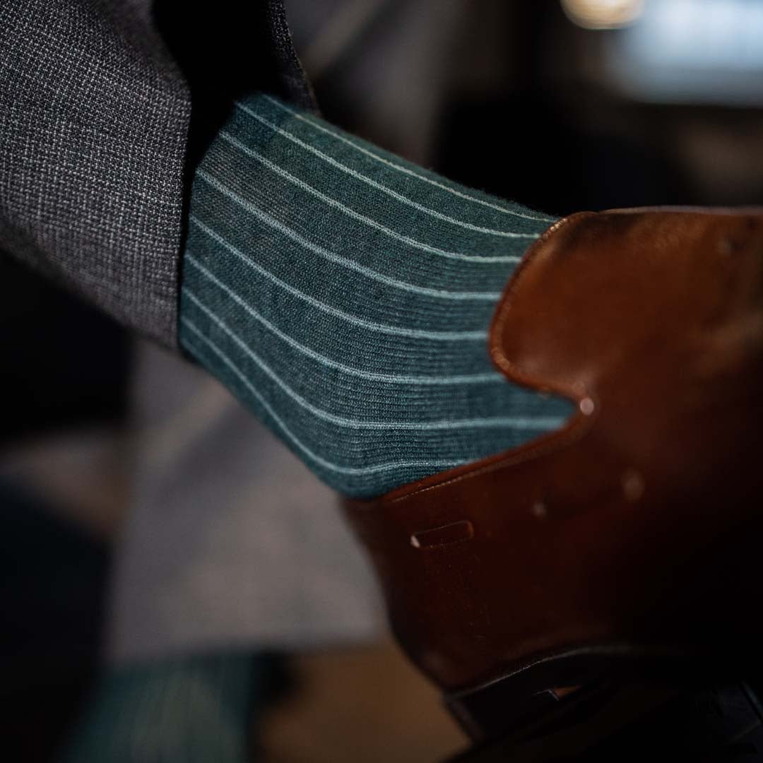 Man wearing hunter green, solid, Emerald ribbed men's dress socks with brown shoes.