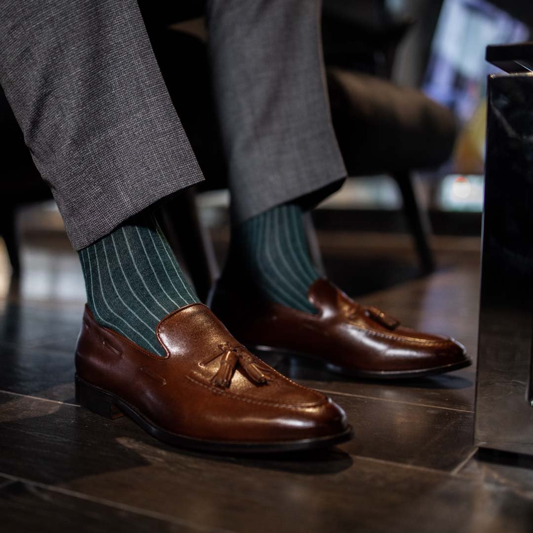 Man wearing hunter green, solid, Emerald ribbed men's dress socks with brown shoes.