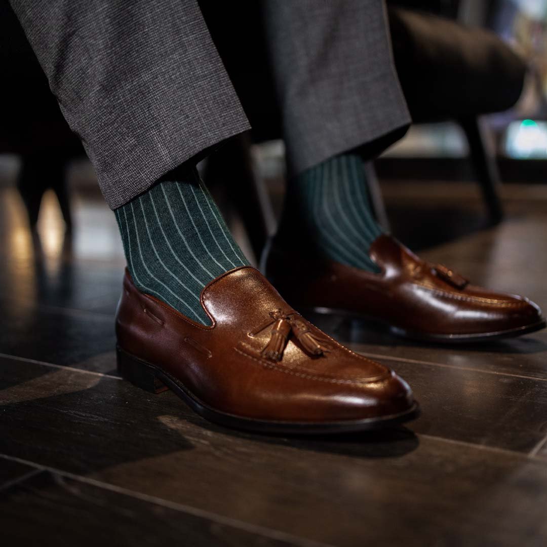 Man wearing hunter green, solid, Emerald ribbed men's dress socks with brown shoes.
