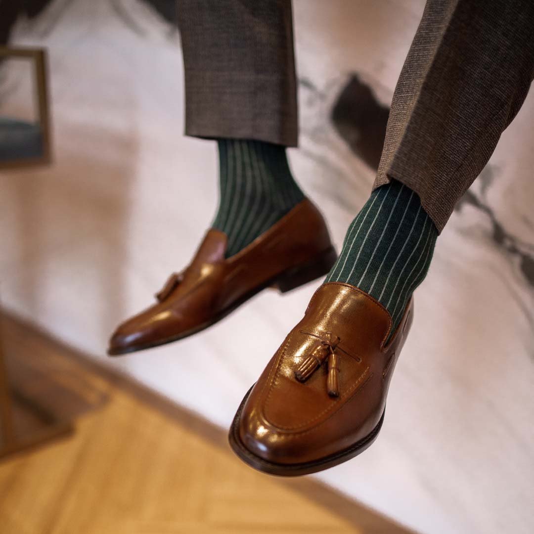 Man wearing hunter green, solid, Emerald ribbed men's dress socks with brown shoes.