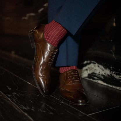 Man wearing solid, merlot ribbed men's dress socks with brown shoes.