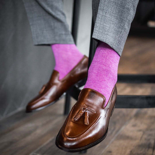 Man wearing fuchsia men's dress socks and brown shoes