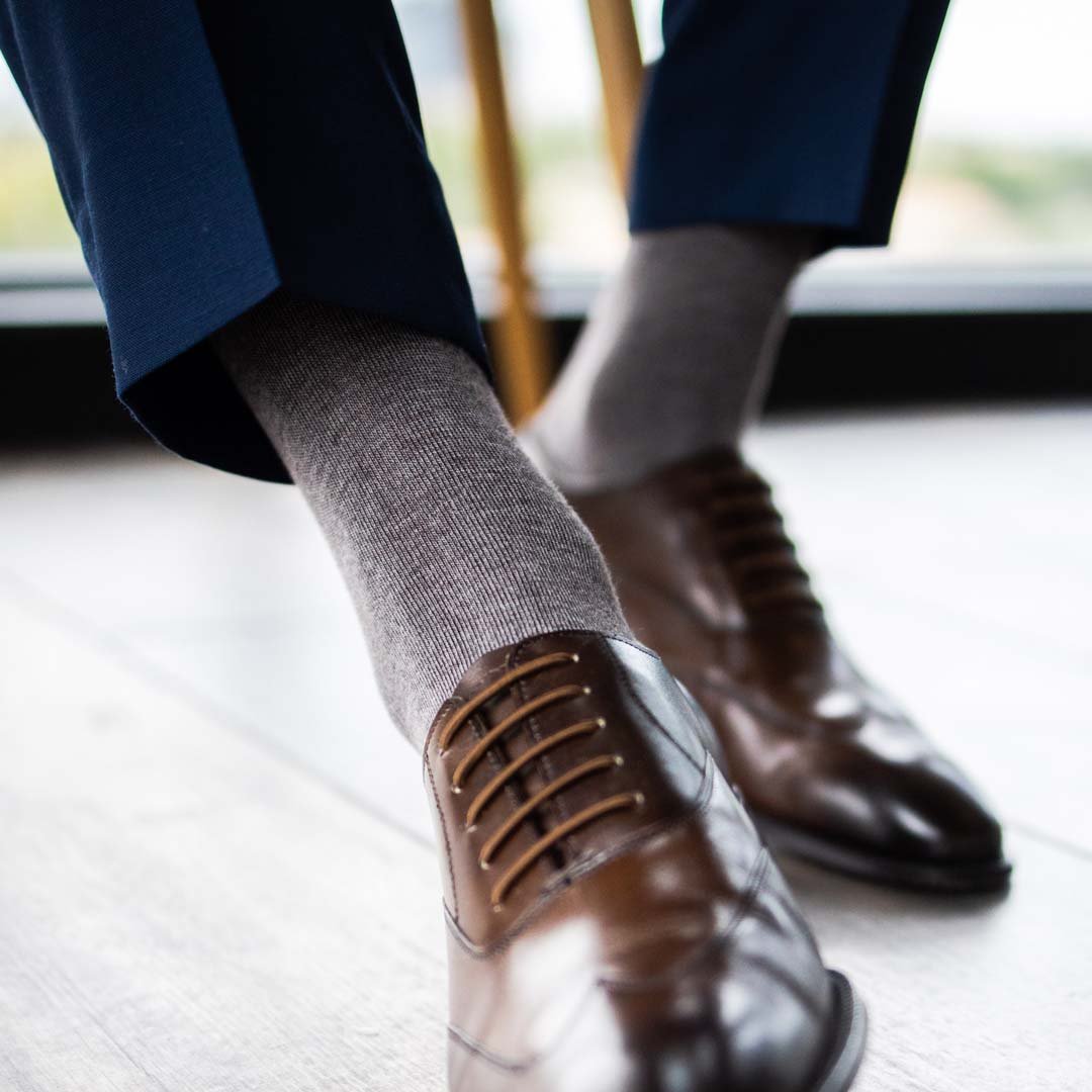 Man wearing steel gray men's dress socks.