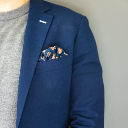 blue and brown floral patterned italian silk pocket square with navy blue suit and grey sweater