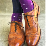 Man wearing purple dress socks with white hatches and brown dress shoes